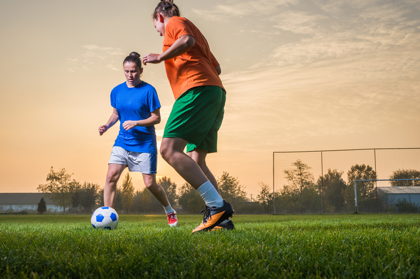 Likes playing football. Boys and girls playing Football Movers. People Running on the grassland.